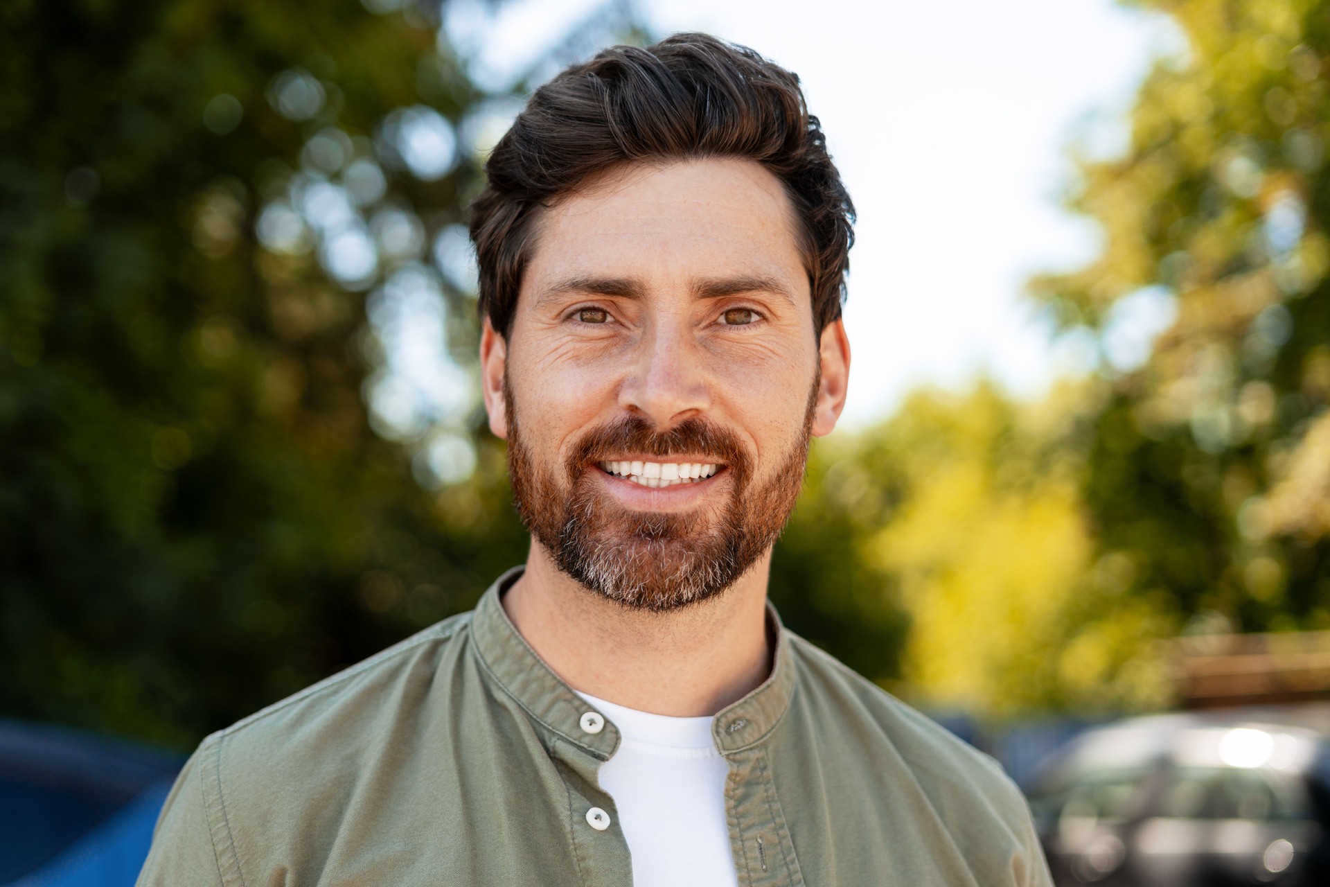 Portrait of a smiling man enjoying a sunny day in nature